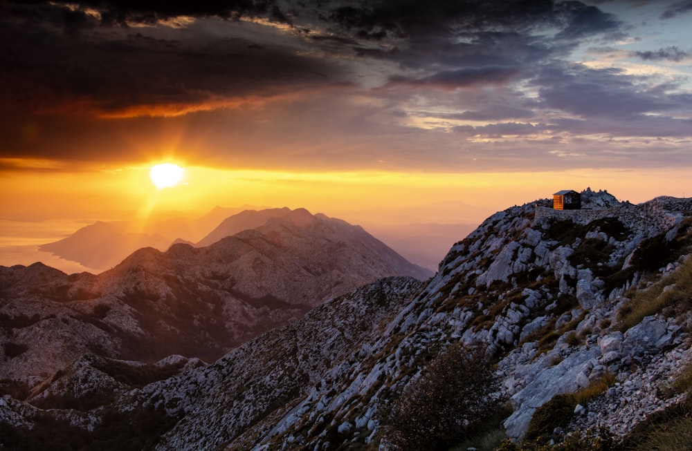 a rocky mountain with a building on top