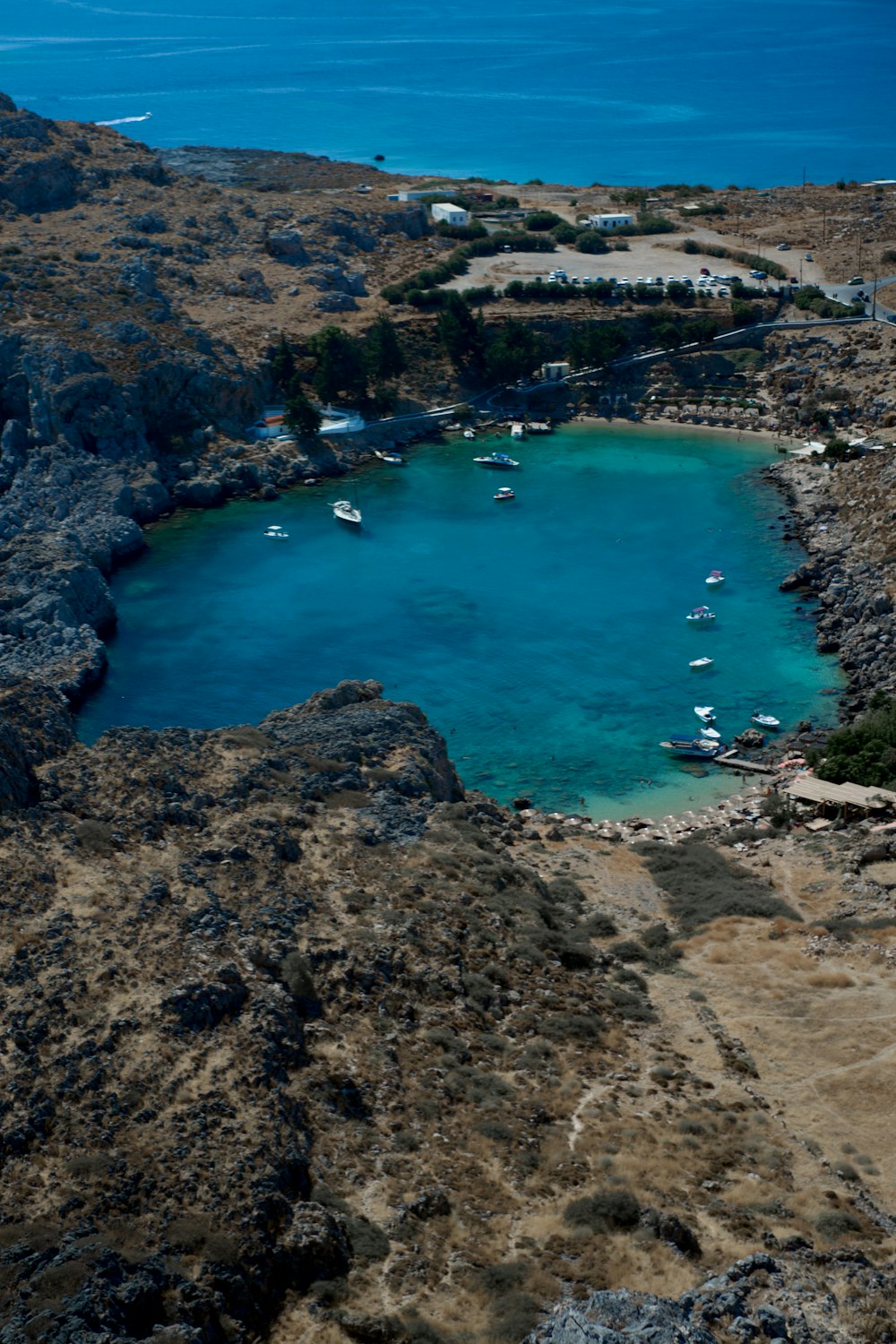 a body of water with boats in it and a land with trees