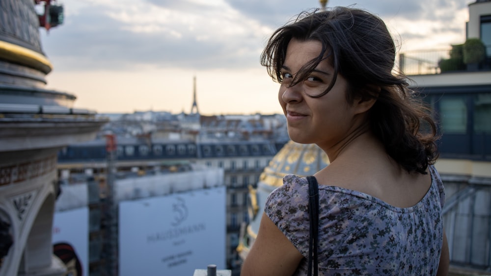 a woman with a city in the background