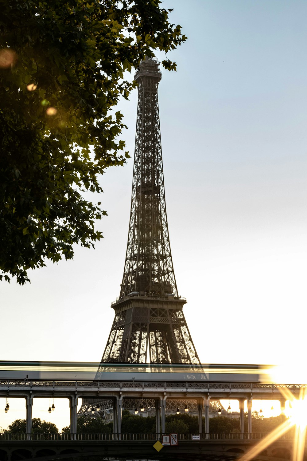 a tall metal tower with Eiffel Tower in the background