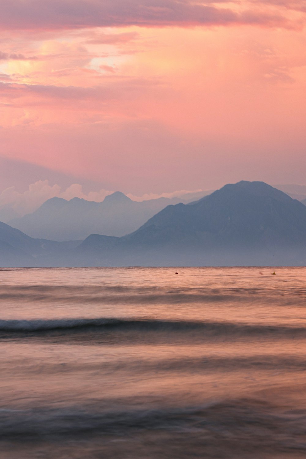 a body of water with mountains in the background