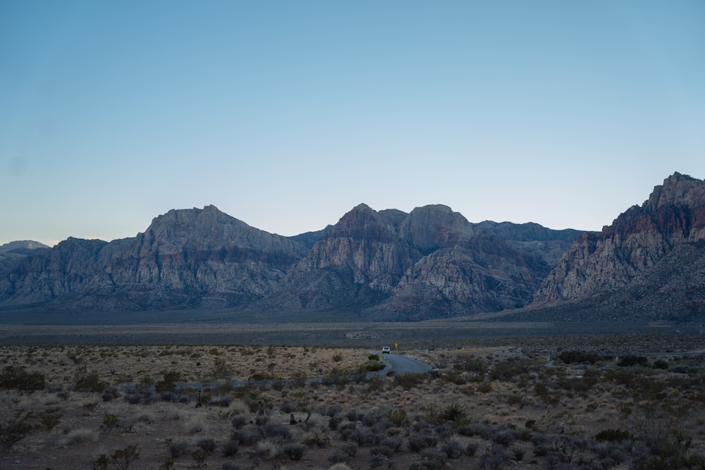 a desert landscape with mountains in the background