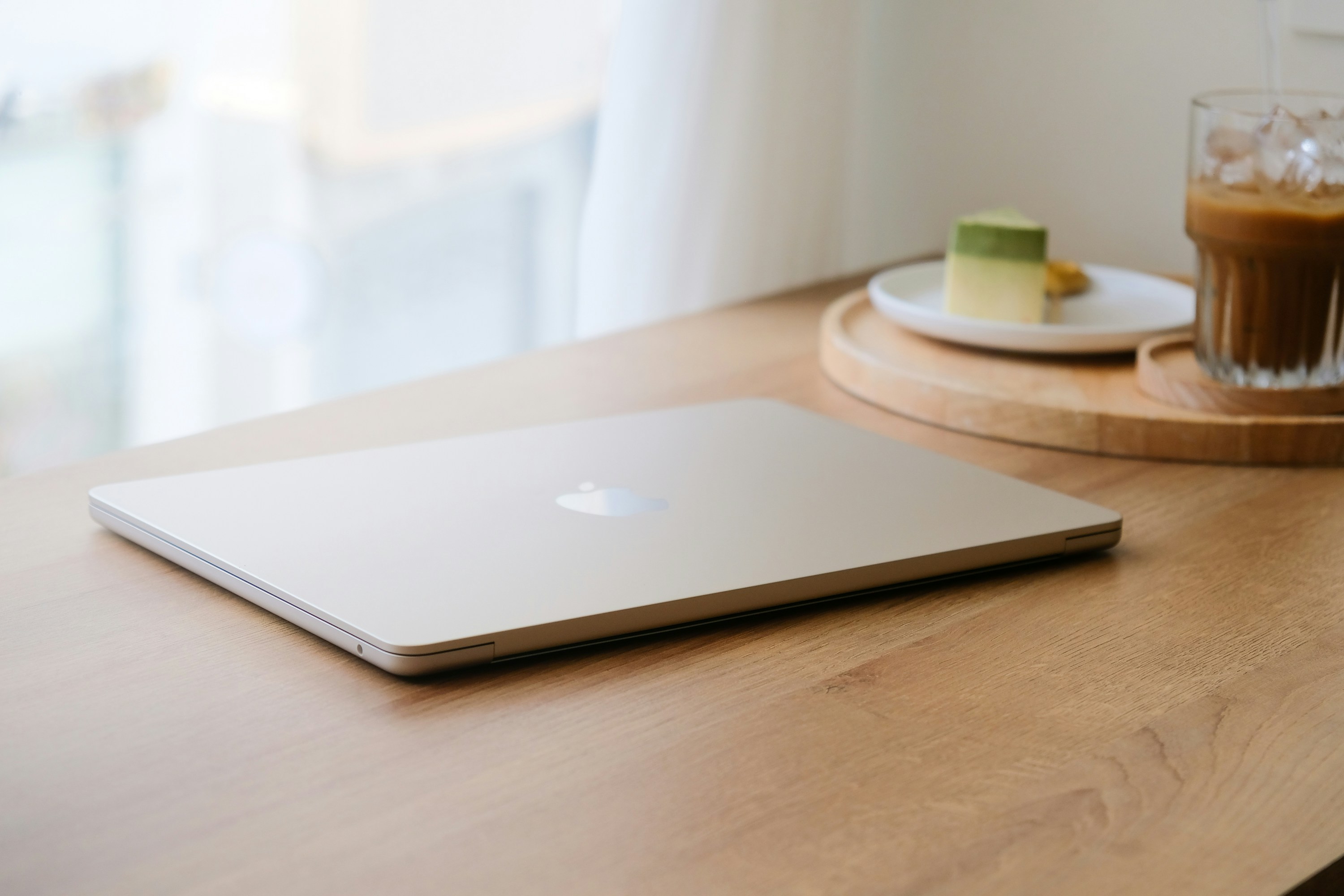A clean, modern home interior featuring a laptop and real estate documents, representing an efficient transaction.