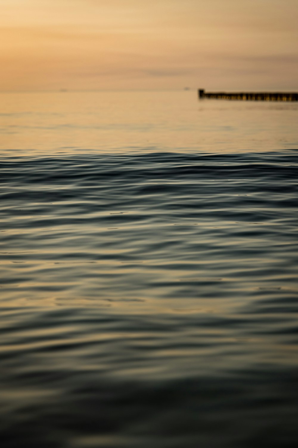 a body of water with a dock in the distance