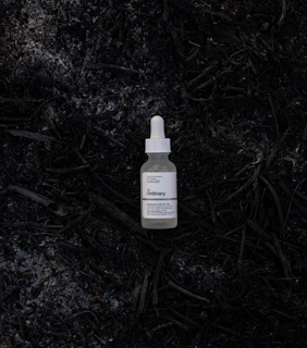 a bottle of liquid on the ground
