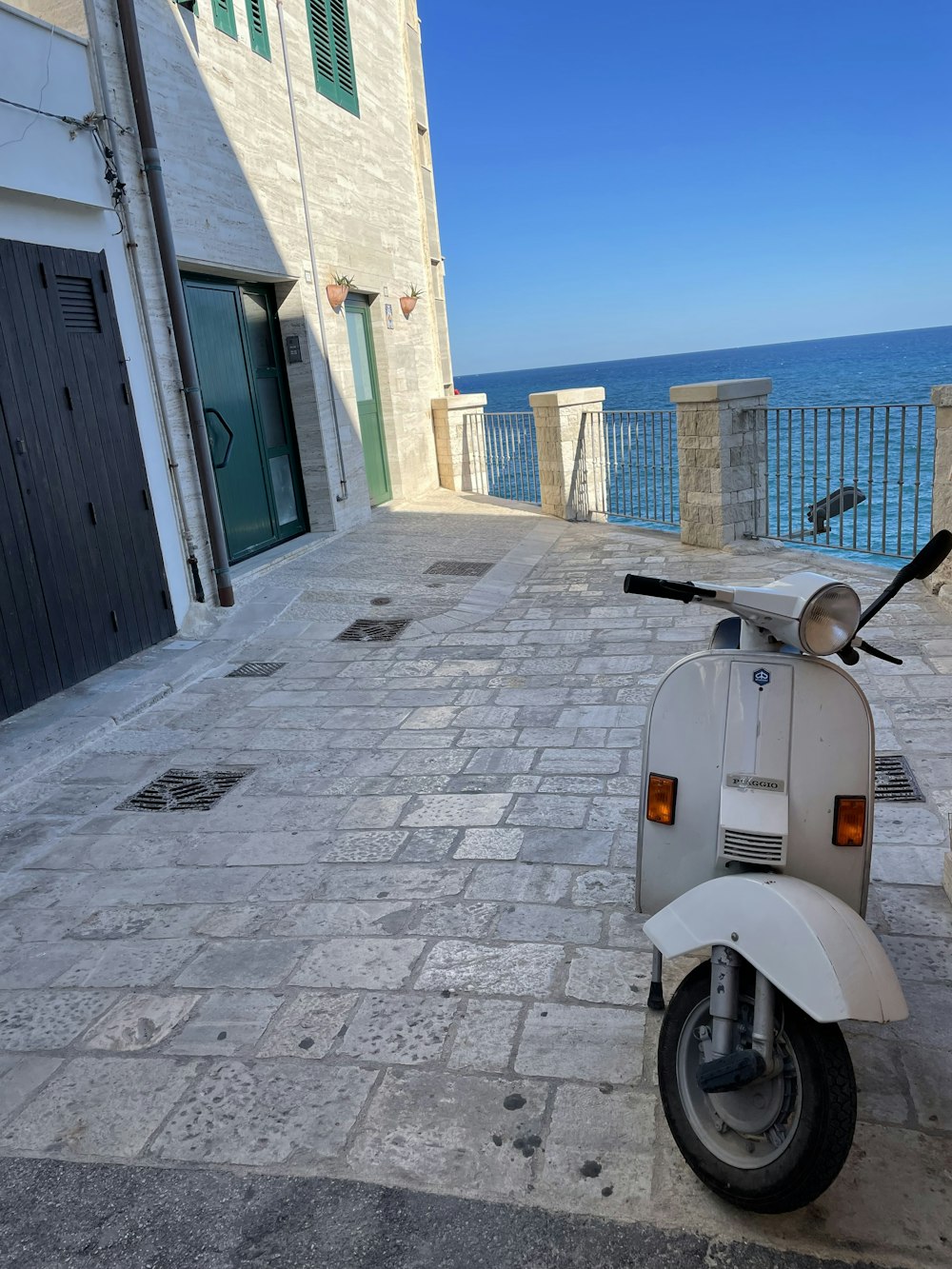 a scooter parked on a cobblestone street