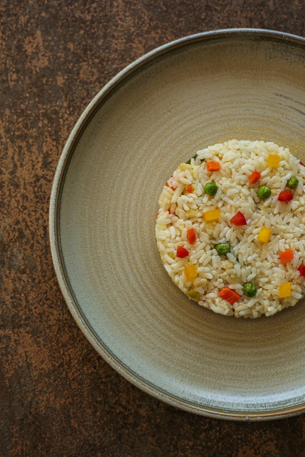 a plate of rice with vegetables