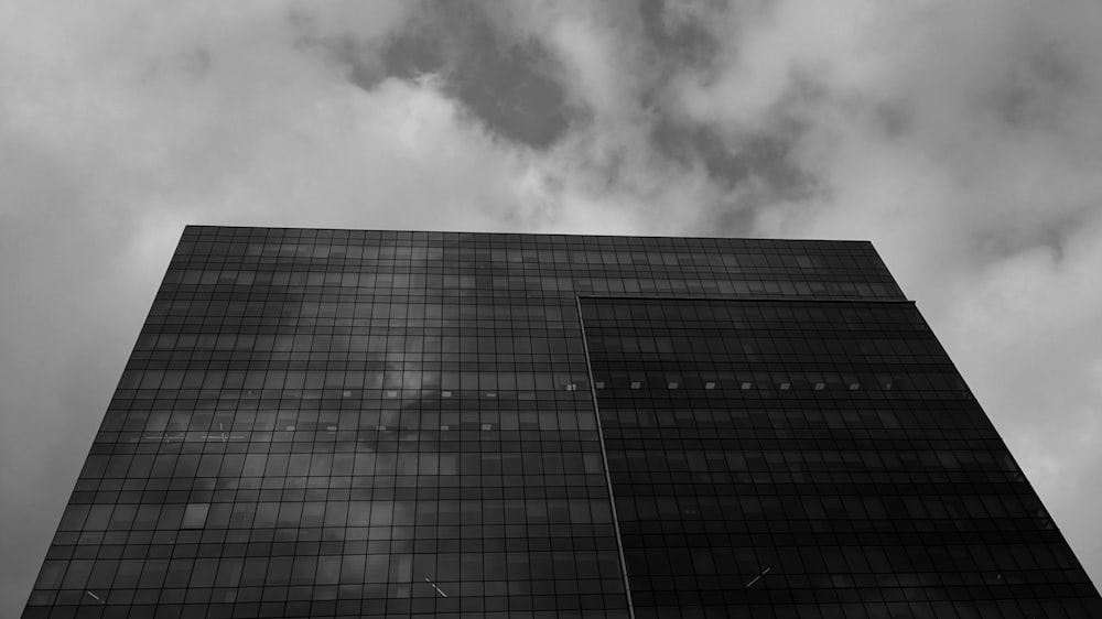 a tall building with clouds in the sky