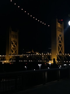 Evening view of a completed bridge illuminated, symbolizing connection and progress.