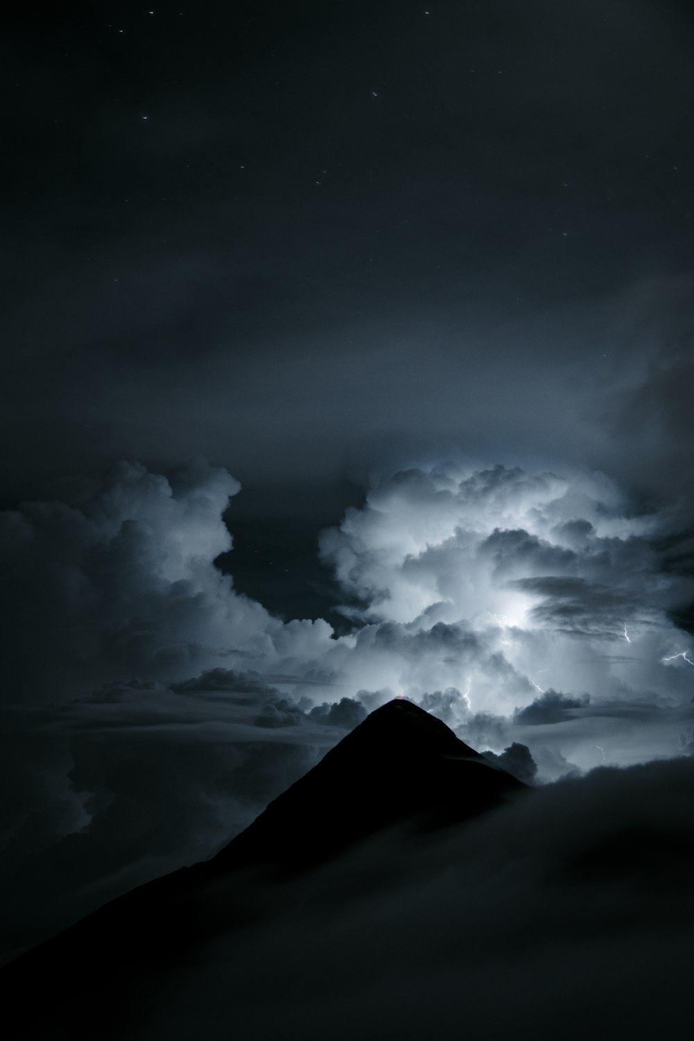 a mountain with clouds above it