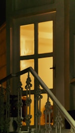 Warm cozy home entrance with security camera and soft golden lighting.