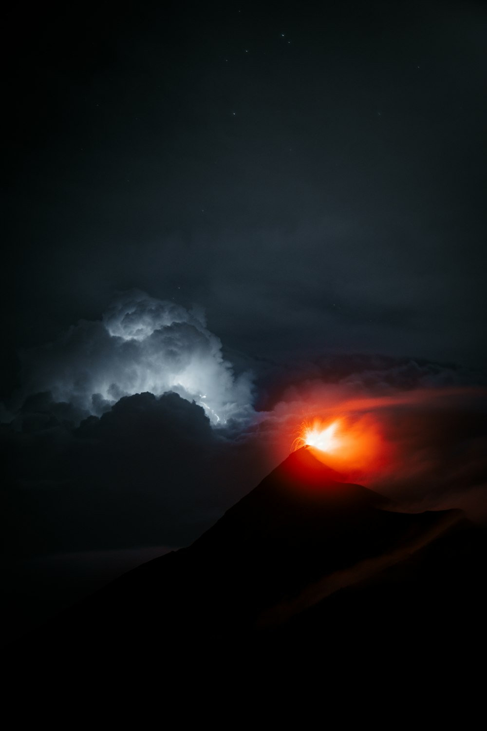 a volcano erupting at night