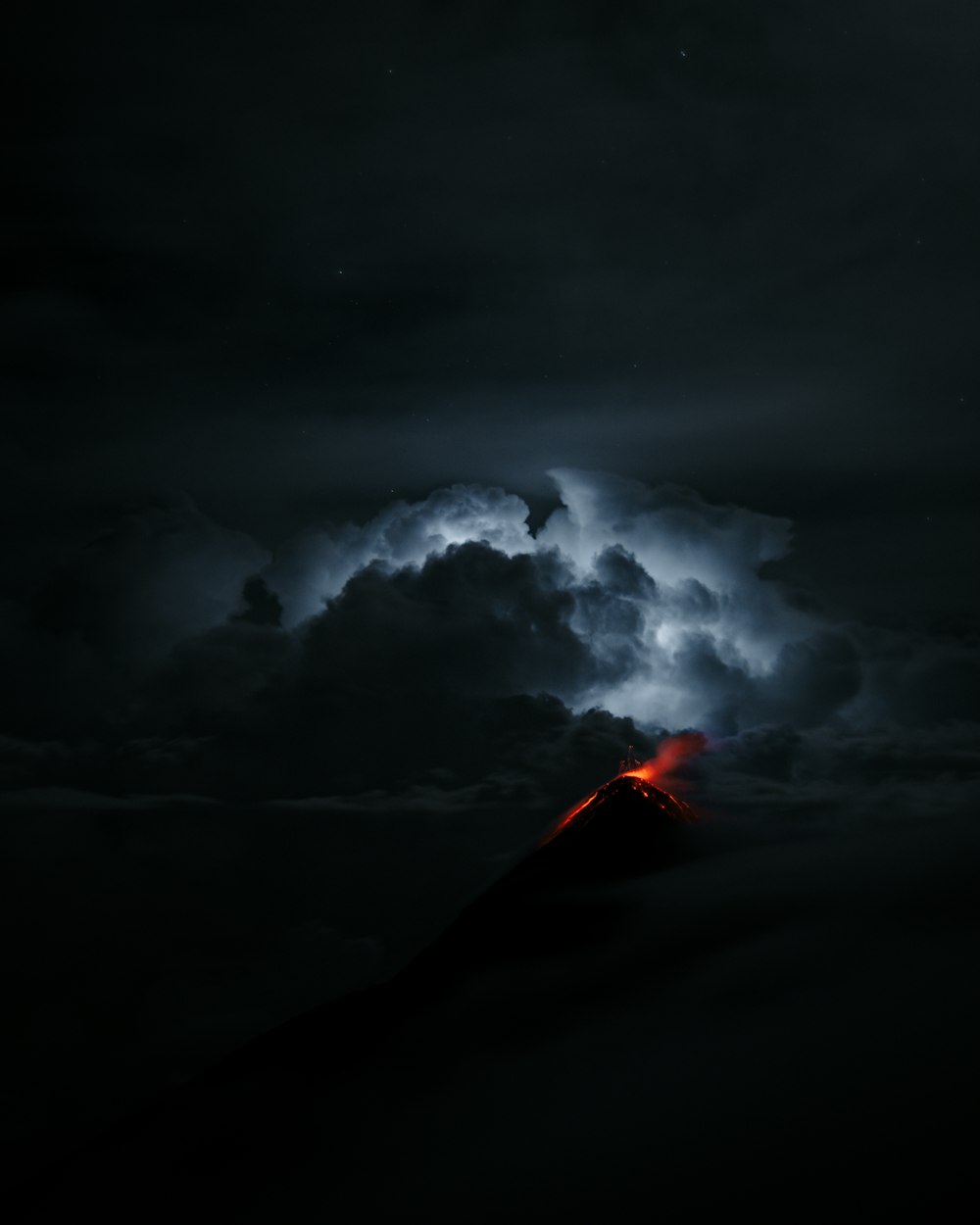 a volcano erupting at night