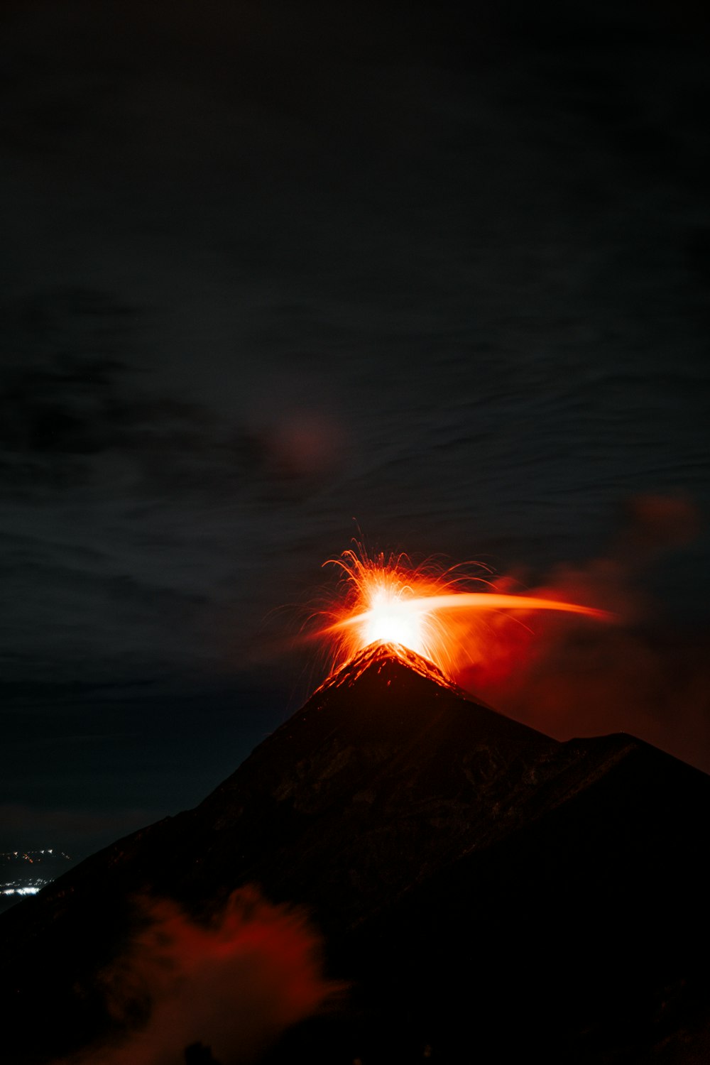 a volcano erupting at night