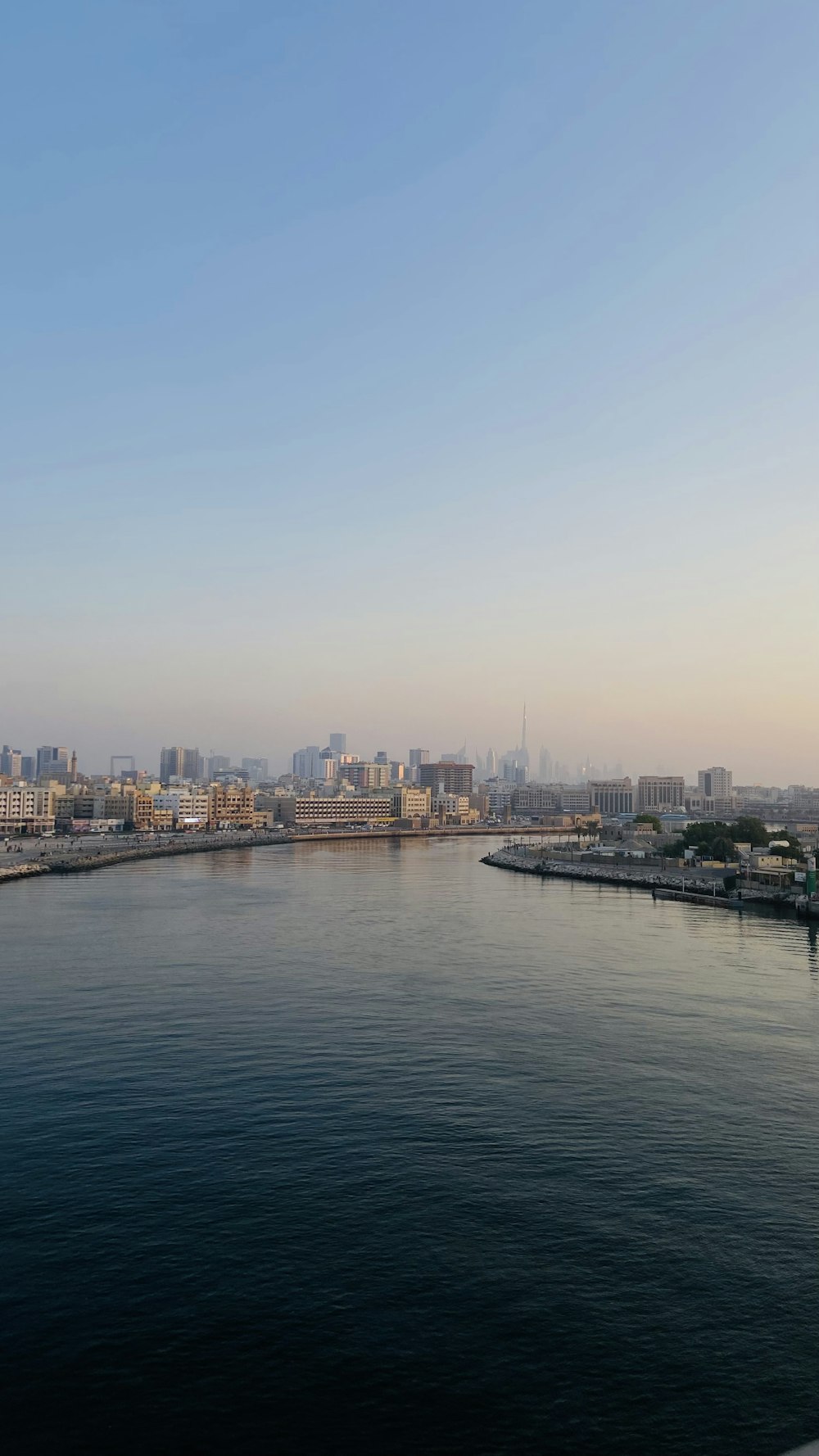 a body of water with a city in the background