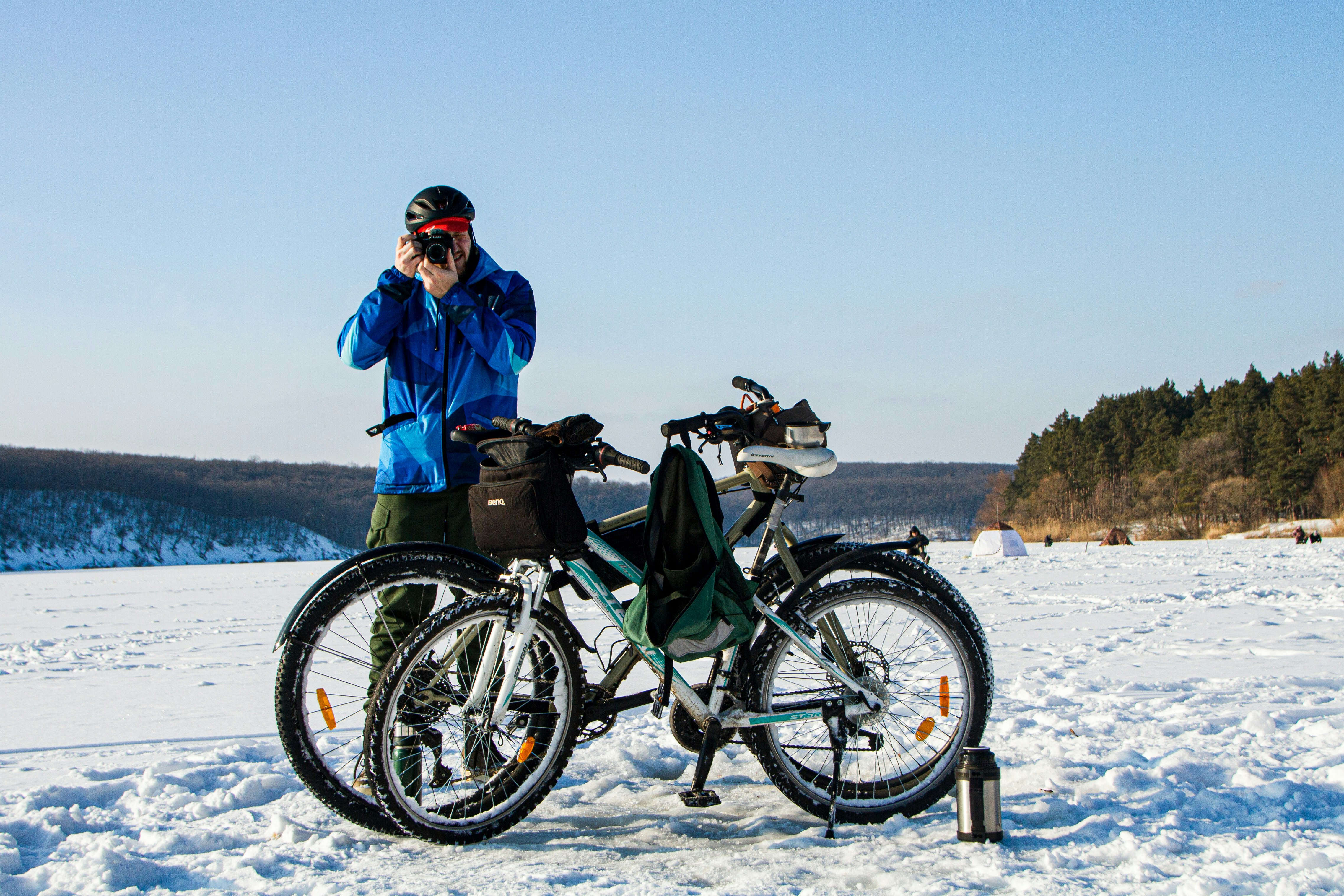 a man standing next to a bicycle