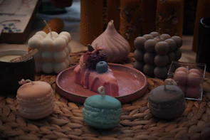 A collection of colorful decorative candles arranged artfully on a rustic shelf.