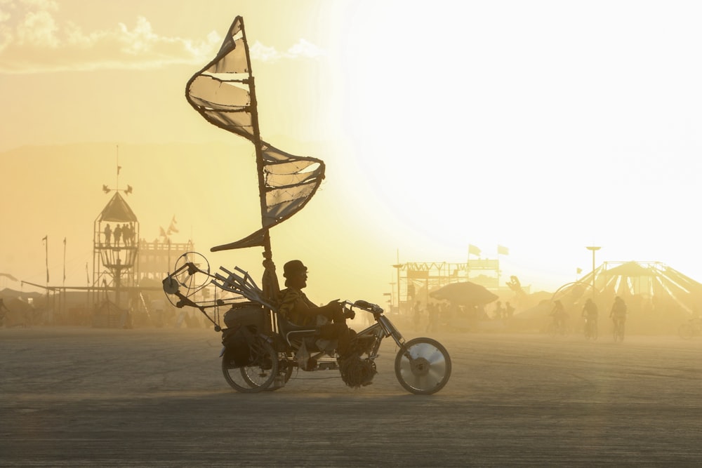 a person riding a motorcycle with a flag on it