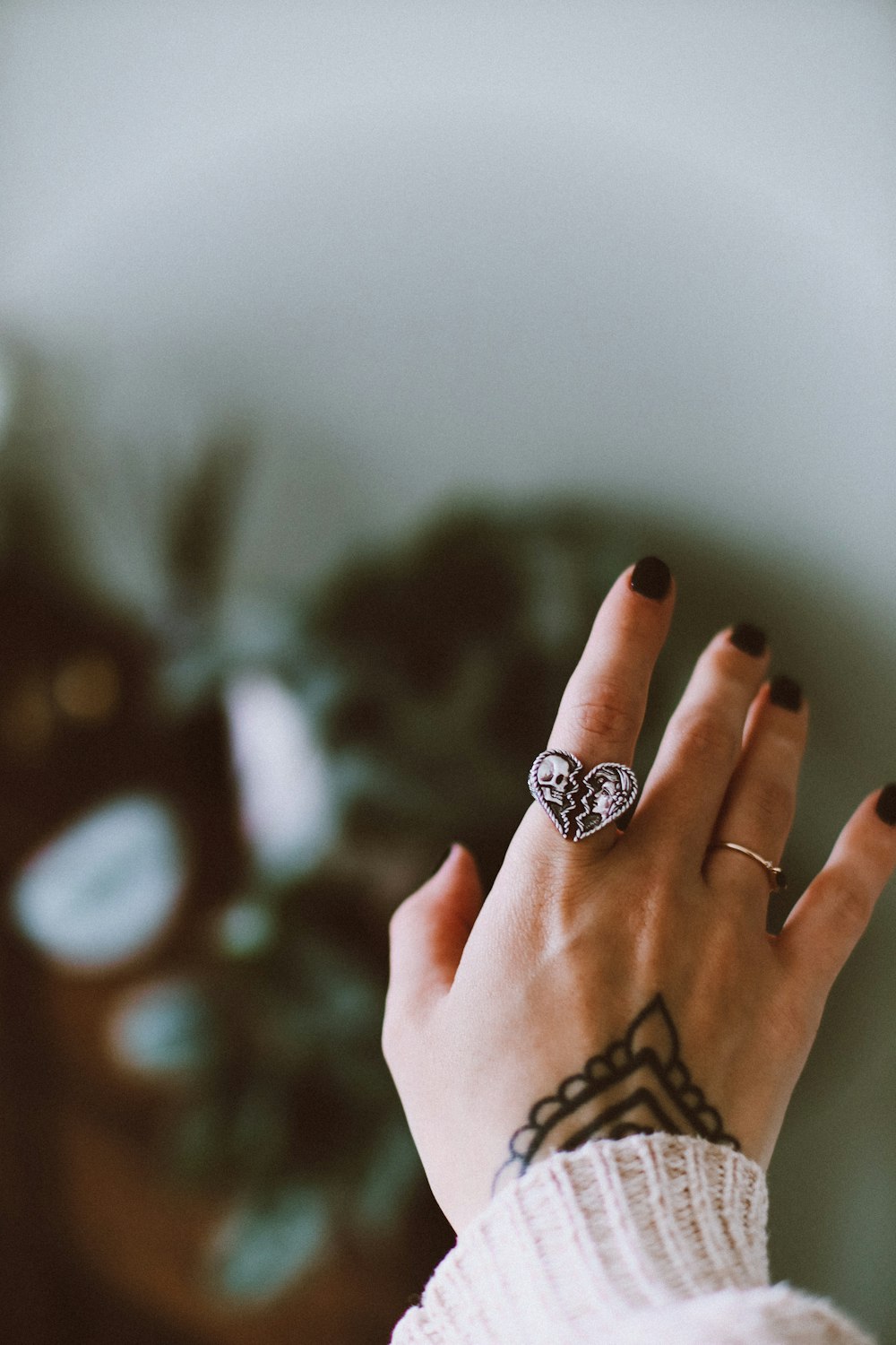 a woman's hand with a tattoo on her finger