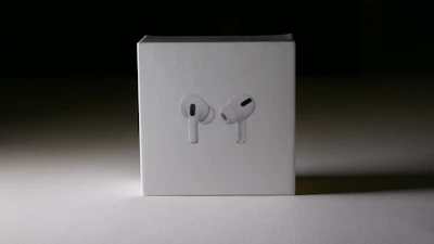 Premium audio headset displayed on a minimalist white background with sage green highlights.