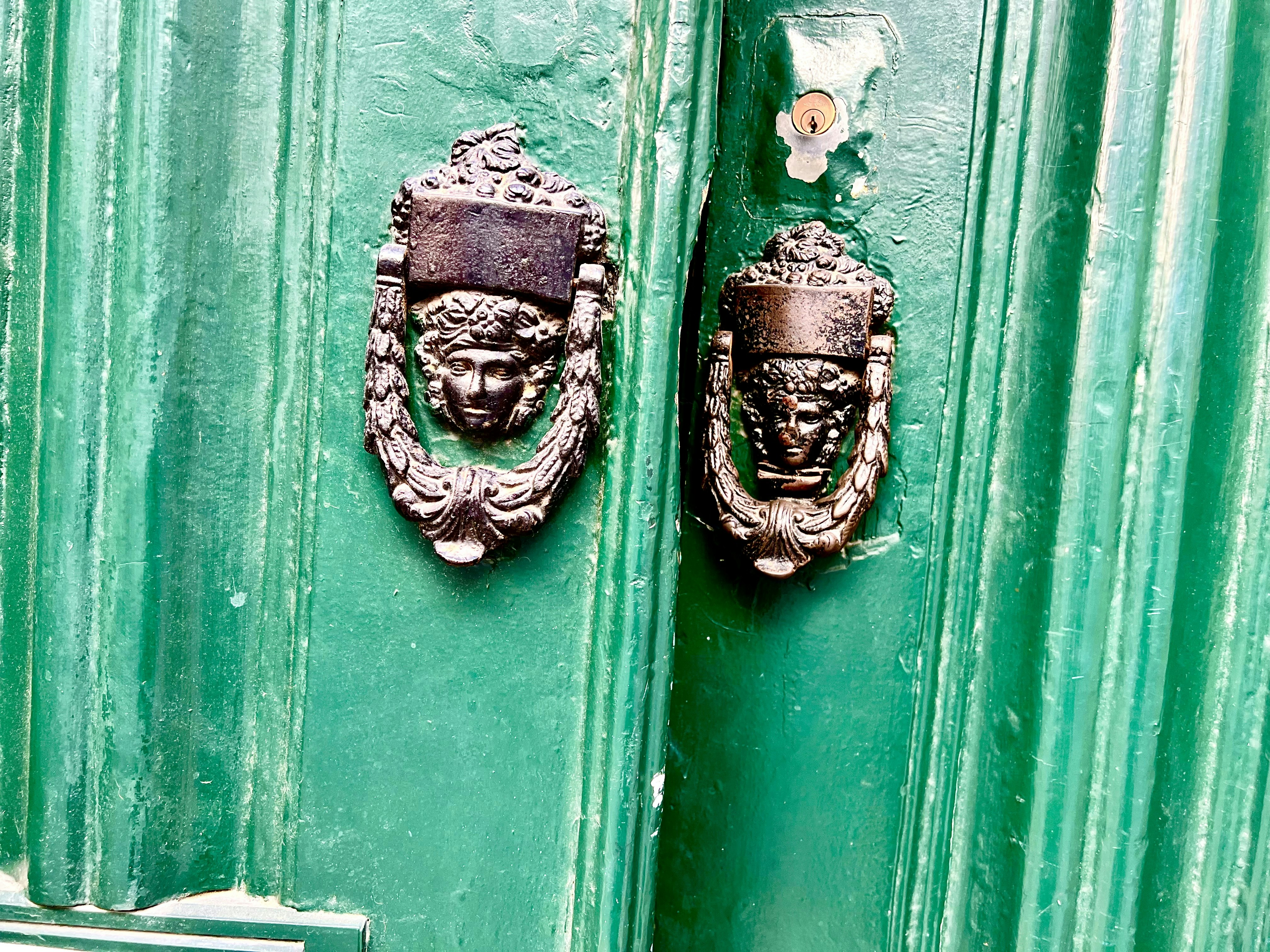 a pair of masks on a green surface