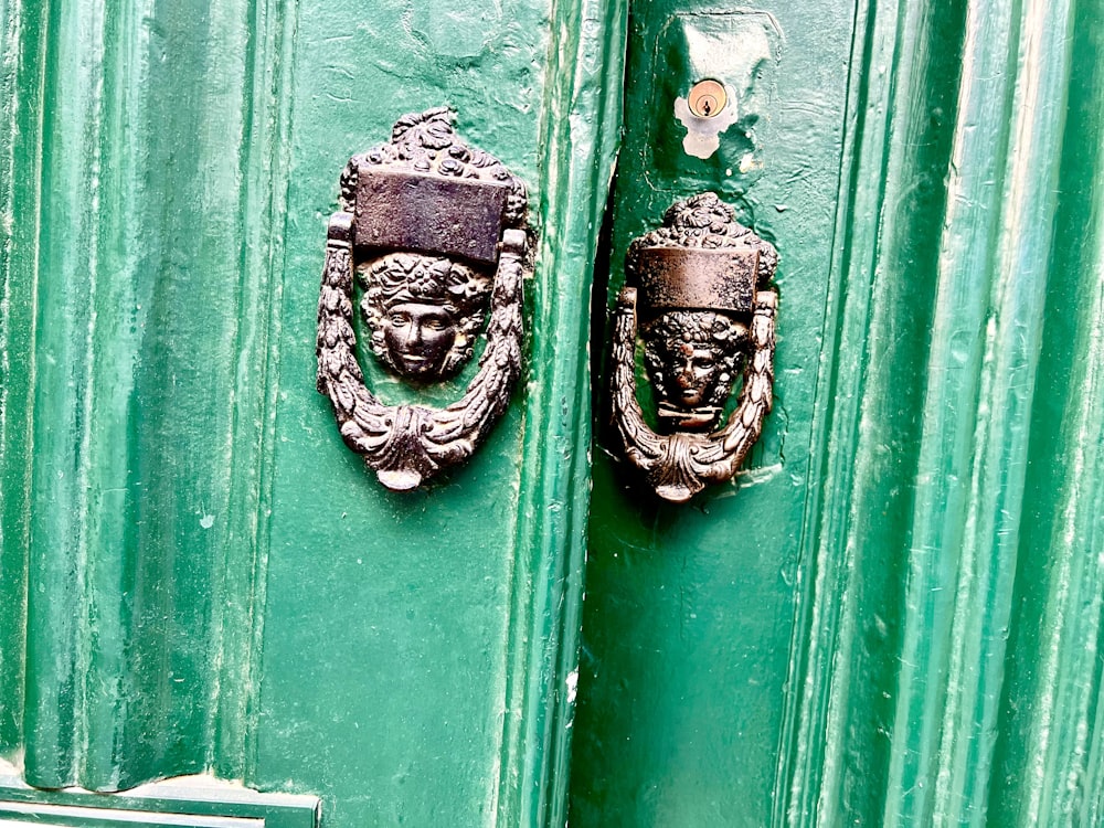 a pair of masks on a green surface