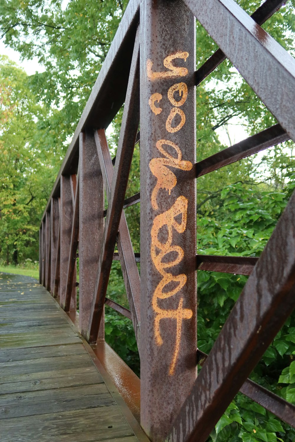 a wooden bridge with a wooden railing