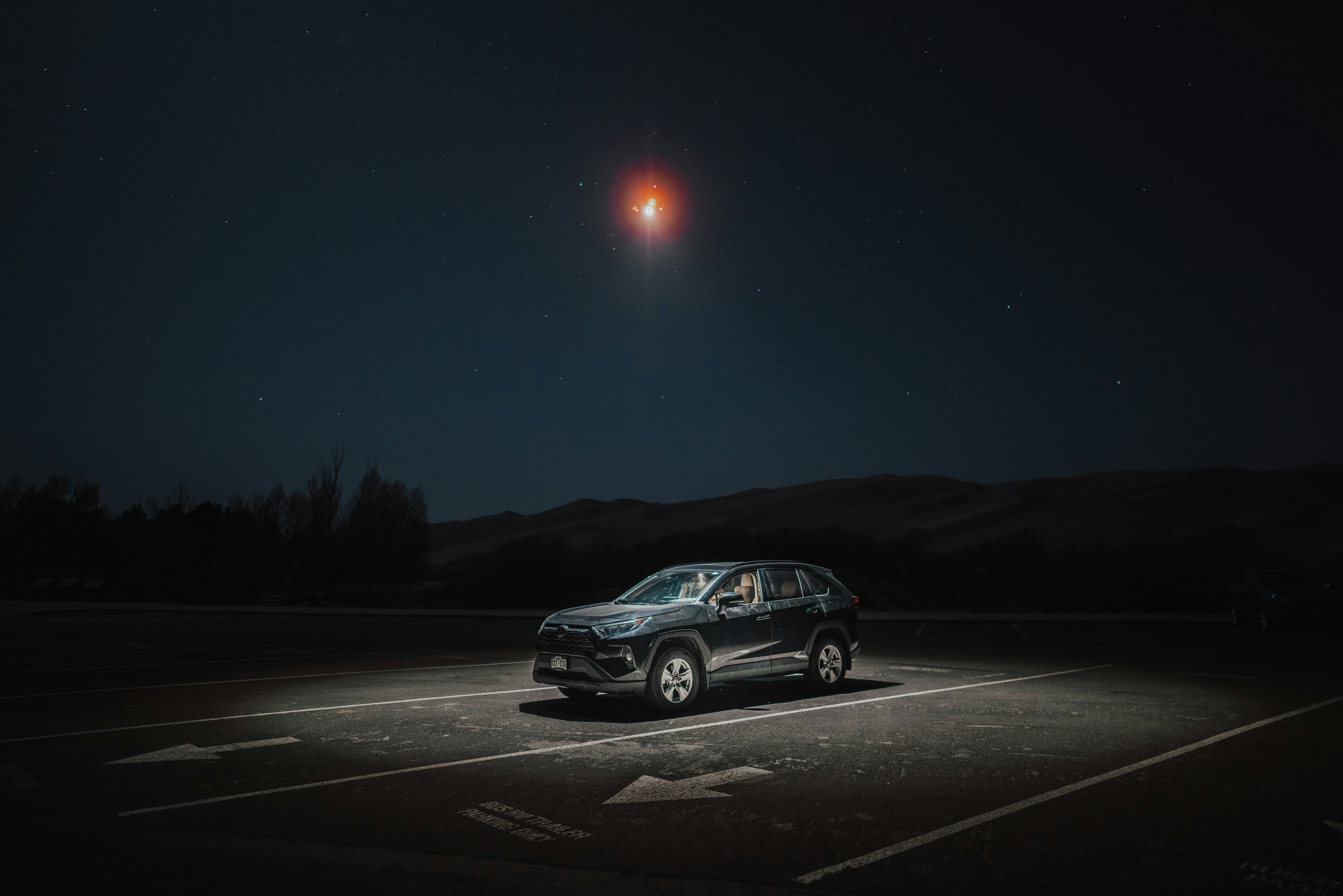 a car parked in a parking lot at night