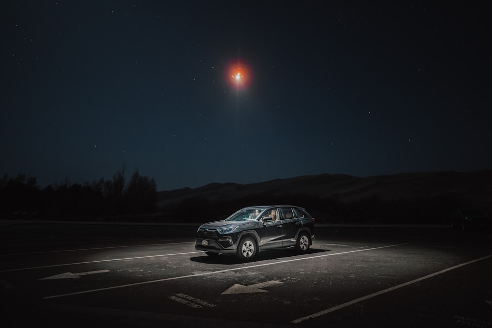 a car parked in a parking lot at night