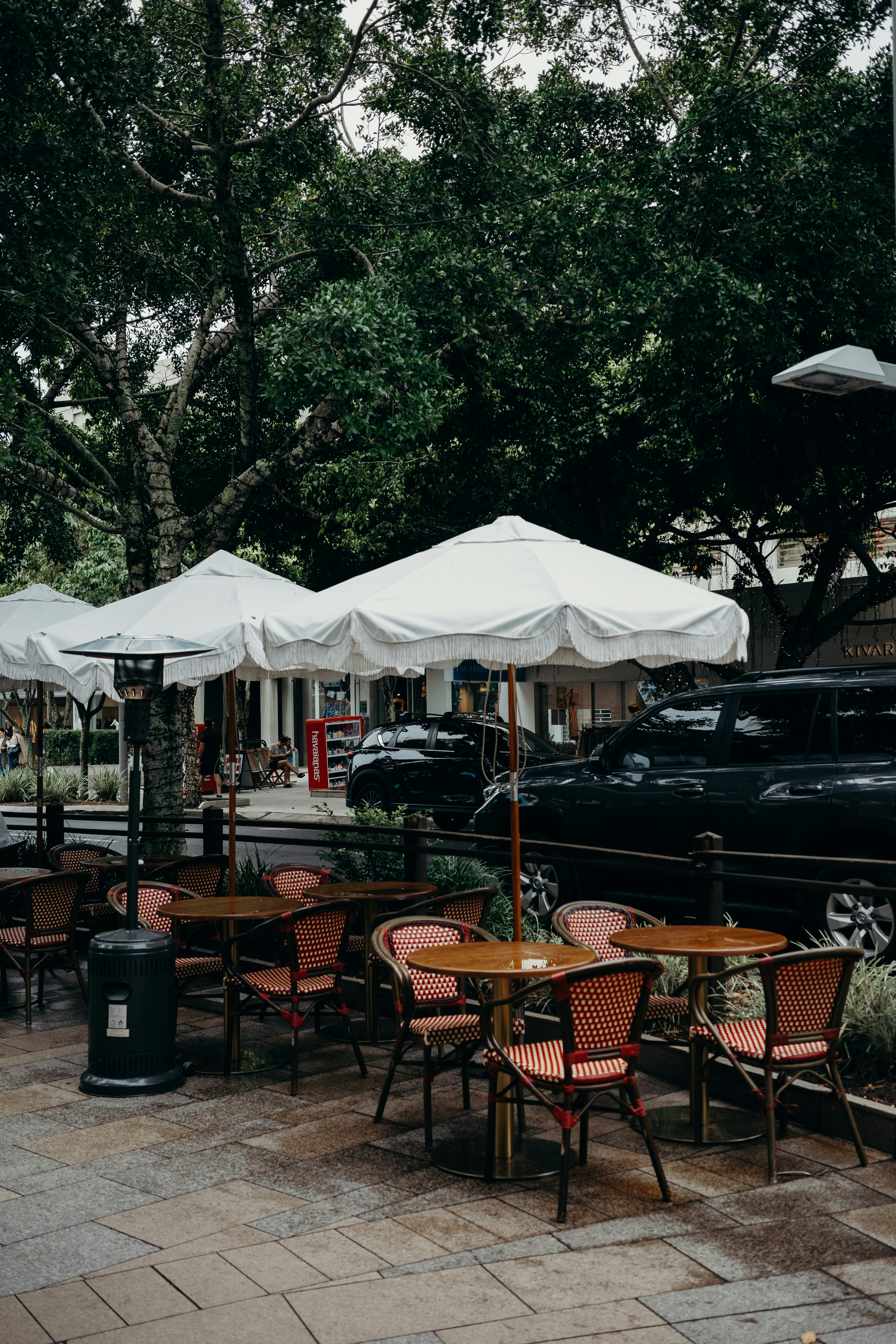 a group of tables and chairs outside in noosa
