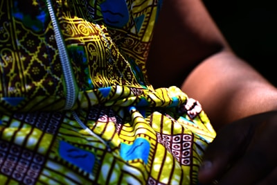 a person holding a colorful snake