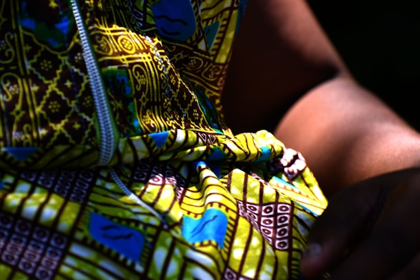 a person holding a colorful snake
