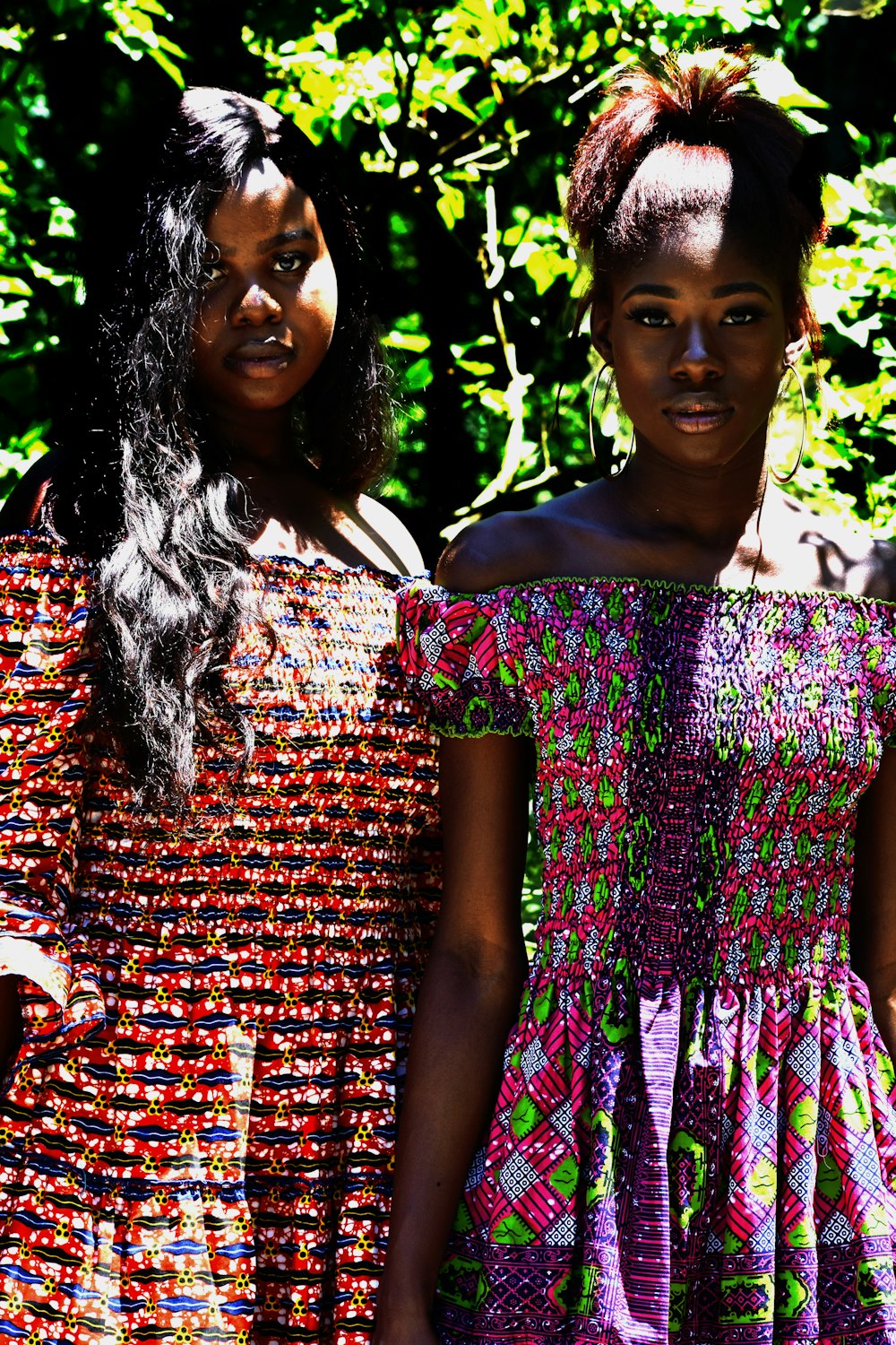 two women wearing dresses