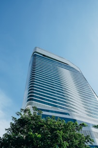 High-rise building with glass facade under a clear blue sky