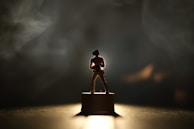 A silhouette of a nominee standing tall under a spotlight, symbolizing their boss energy.