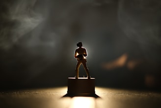 A silhouette of a nominee standing tall under a spotlight, symbolizing their boss energy.