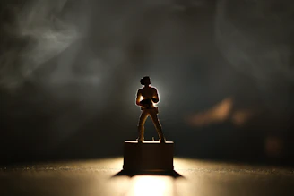 Pop culture icon figure displayed on a sleek pedestal with soft lighting.