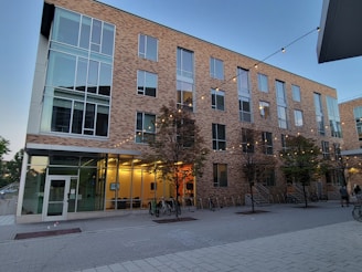 a building with trees and bikes outside