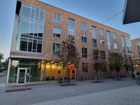 a building with trees and bikes outside