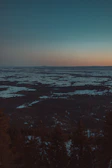 A cinematic landscape showing a desert meeting a snowy Nordic forest, blending two worlds seamlessly.