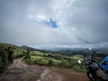 a motorcycle parked on a dirt road