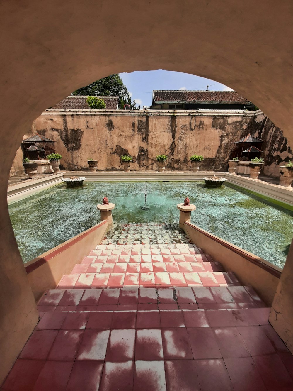 a pool with a brick walkway