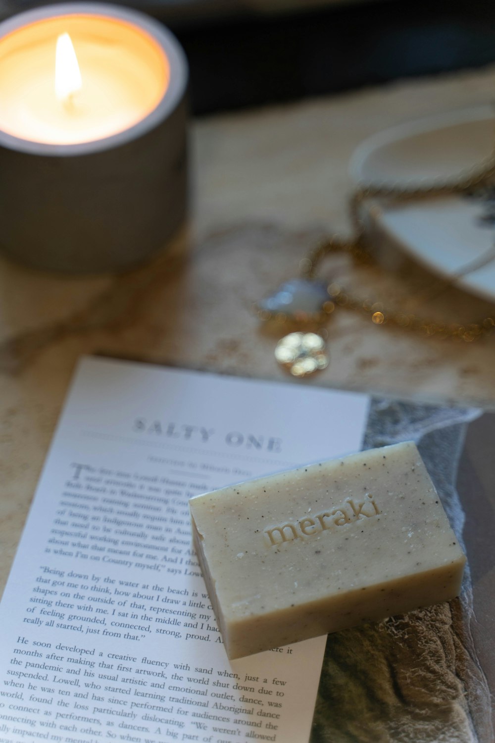 a book and a candle on a table