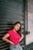 A young woman confidently posing in a stylish outfit, radiating joy and self-assurance.