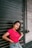 A young woman confidently posing in a stylish outfit, radiating joy and self-assurance.