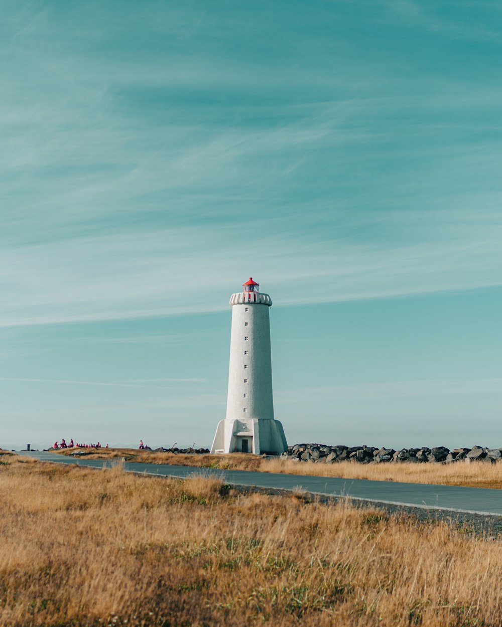 a lighthouse on a grassy hill