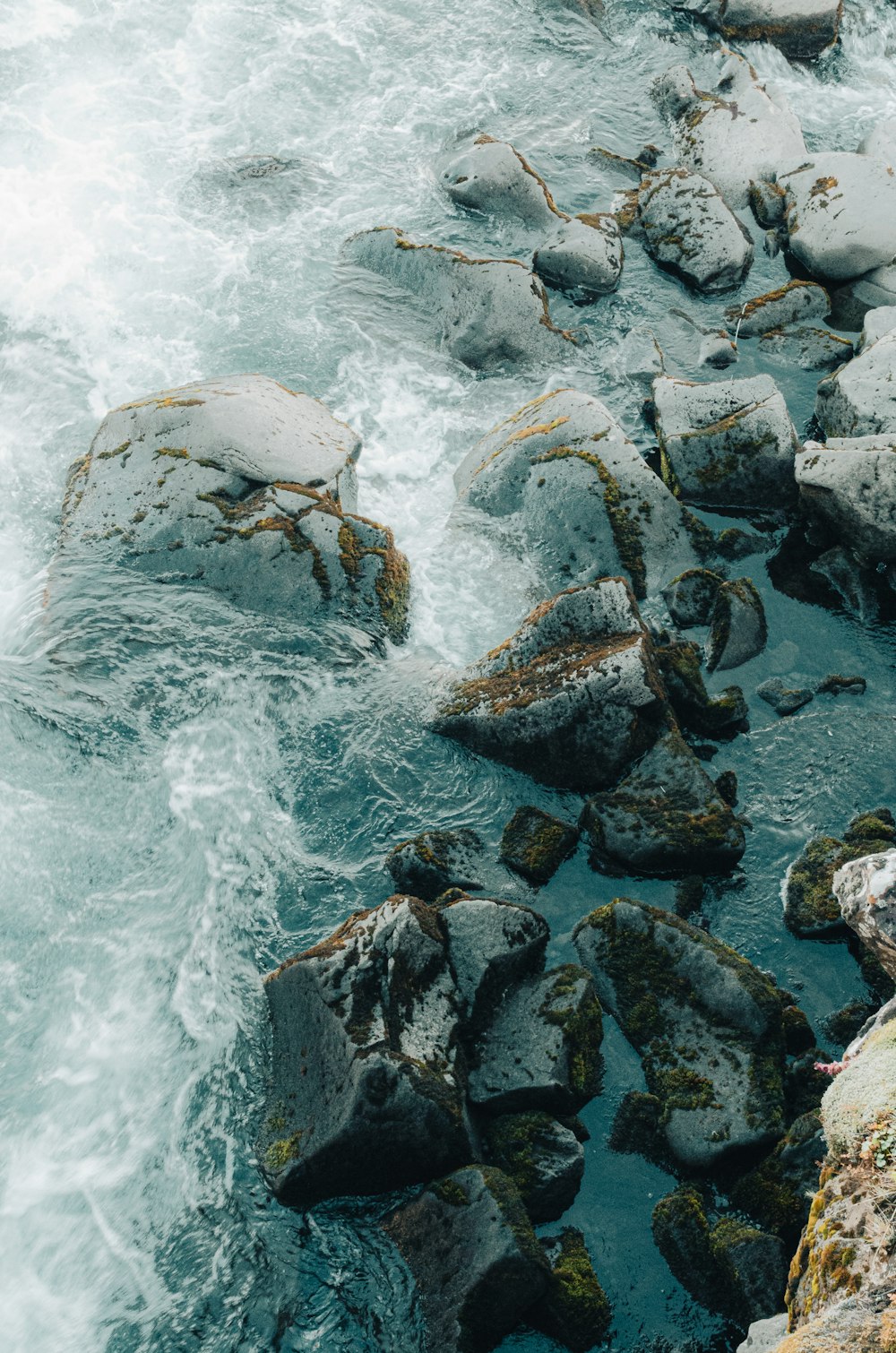 a group of rocks in a body of water