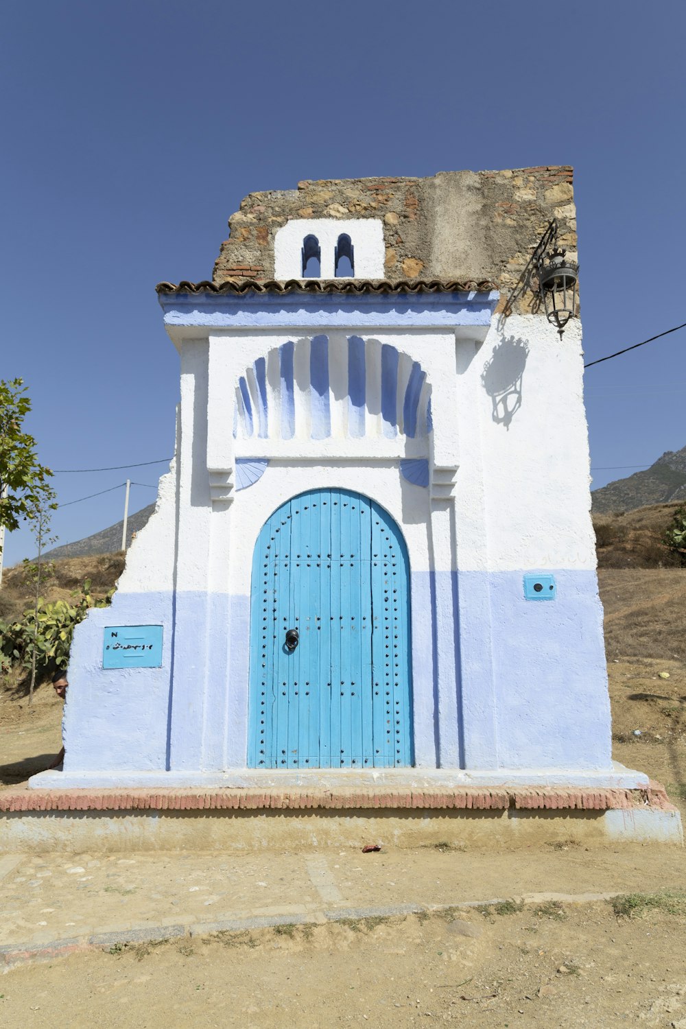 a white building with a blue door