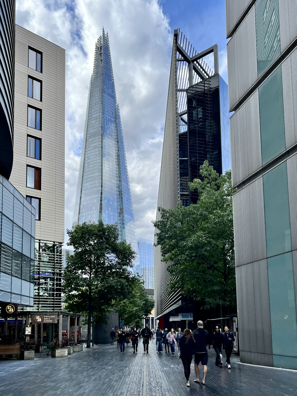 a group of people walking between tall buildings