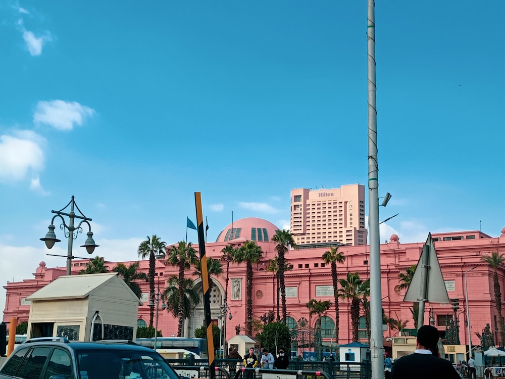 a pink building with a flag pole